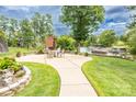 Outdoor patio with a brick fireplace, ample seating, and serene views of the lake at 2580 Penngate Dr, Sherrills Ford, NC 28673