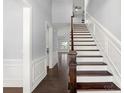 Bright entryway with hardwood floors, stairs with dark treads, and high ceilings at 2830 Berkhamstead Cir, Concord, NC 28027