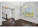 Elegant room with dark wood floors, white trim, and large arched window with abundant natural light at 2830 Berkhamstead Cir, Concord, NC 28027