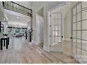 Bright foyer with hardwood floors, iron railing, and view of living area at 298 Horton Grove Rd, Fort Mill, SC 29715
