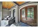 Inviting front porch with double doors, stone floor, and cozy seating at 298 Horton Grove Rd, Fort Mill, SC 29715