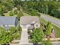 Aerial view of a brick two-story home with manicured lawn, landscaping, and an attached two-car garage at 300 Hidden Cove Ln, Matthews, NC 28104