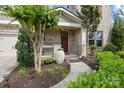 Inviting front porch with mature landscaping, walkway, and a decorative urn at the front door at 300 Hidden Cove Ln, Matthews, NC 28104
