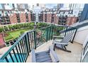 Inviting balcony space with comfortable chairs overlooking a serene courtyard with lush greenery and a pool at 300 W 5Th St # 644, Charlotte, NC 28202