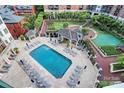 Aerial view of a refreshing outdoor pool area surrounded by lounge chairs, tables, and well-manicured landscaping at 300 W 5Th St # 644, Charlotte, NC 28202