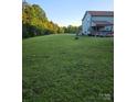 Expansive backyard featuring a deck with a jacuzzi and an outdoor seating area at 3401 Shillinglaw Rd, Sharon, SC 29742