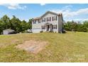 Two-story home with an attached garage and a large, grassy front yard on a sunny day at 3401 Shillinglaw Rd, Sharon, SC 29742