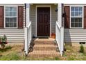 Front porch features brick steps, white railings, and lantern decorations at 3401 Shillinglaw Rd, Sharon, SC 29742