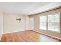 Sunny living room with fresh paint, wood floors, and a view of the front yard at 3455 Hickory Pl, Salisbury, NC 28144