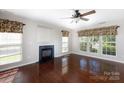 Bright living room with hardwood floors, fireplace, and large windows at 4642 Laurendale Ct, Rock Hill, SC 29732