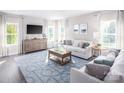 Well-lit living room with comfortable seating, modern furnishings, and ample natural light from multiple windows at 518 Durango Way, Denver, NC 28037