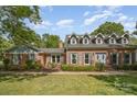 Beautiful brick home featuring dormer windows and well-maintained landscaping for inviting curb appeal at 6040 Morris Farm Ln, Mint Hill, NC 28227