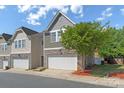 Charming townhome featuring a two-car garage and beautiful stone accents on the facade at 7341 Adare Mews Rd, Charlotte, NC 28217