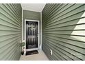 Welcoming entryway featuring a stylish black door with a decorative wreath and cozy decor at 7341 Adare Mews Rd, Charlotte, NC 28217