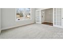 Sunlit bedroom boasts plush carpeting, neutral walls, and a window with neighborhood views at 9948 Manor Vista Trl, Kannapolis, NC 28027