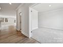 Bright, open-concept living space with hardwood floors, neutral walls, and access to other rooms at 9948 Manor Vista Trl, Kannapolis, NC 28027