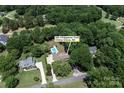 Aerial view of 105 Chippewa Trail property with pool, spacious lot, and tree-lined surroundings in China Grove, NC at 105 Chippewa Trl, China Grove, NC 28023