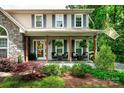 Charming home featuring a welcoming front porch with wood columns and meticulously landscaped front yard at 105 Chippewa Trl, China Grove, NC 28023
