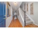 Bright and inviting entryway with hardwood floors, staircase, and stylish decor at 10617 Fuller Ridge Cir, Charlotte, NC 28270