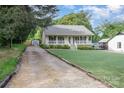 Attractive home showcasing a well-manicured lawn, gravel driveway and charming front porch at 113 Marina Ln, Mooresville, NC 28117