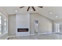Bright living room boasts a fireplace, neutral walls, and views to the bathroom at 115 Falling Creek Dr, Statesville, NC 28625
