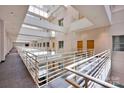 Well-lit hallway featuring multiple levels and contemporary railings, enhancing a bright and modern living space at 127 N Tryon St # 404, Charlotte, NC 28202