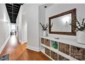 A stylish hallway with hardwood floors, decorative storage, and modern accents to create a welcoming entry at 127 N Tryon St # 404, Charlotte, NC 28202