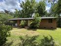 Single-story brick home featuring a cozy front entrance with mature trees in a spacious yard at 13134 Homewood Dr, Charlotte, NC 28262
