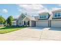 Inviting home exterior featuring a well-kept lawn, stone accents, and an attached two-car garage at 1328 Somersby Cir, Gastonia, NC 28054