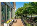 Charming brick porch with black railing, decorative plants, and a view of the neighborhood at 1328 Somersby Cir, Gastonia, NC 28054