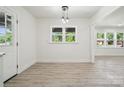Bright dining area featuring wood-look floors, a stylish light fixture, and ample natural light at 1417 W Monroe St, Salisbury, NC 28144