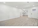 Spacious, open-concept living room with light colored walls and wood-look flooring at 1417 W Monroe St, Salisbury, NC 28144
