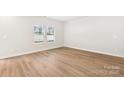 Bright bedroom with wood flooring and two windows overlooking the outdoors at 1421 Wildflower St, Newton, NC 28658