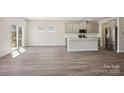 Open-concept living area featuring a modern kitchen with stainless steel appliances and an island at 145 Satchel Ct, Mooresville, NC 28115