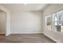 Bright living room with hardwood floors and large windows offering a view of the outdoors at 145 Satchel Ct, Mooresville, NC 28115