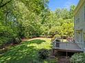 Expansive backyard with a well-maintained lawn, bordered by mature trees, accessible from the deck at 15831 Breton Brook St, Huntersville, NC 28078