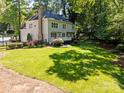 Spacious backyard with lush green lawn and mature trees offering privacy and shade at 15831 Breton Brook St, Huntersville, NC 28078