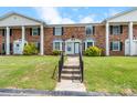 Two-story brick townhomes with well-manicured lawn and concrete walkway and steps at 160 17Th Street Nw Pl, Hickory, NC 28601
