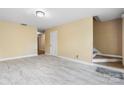 Bright living room featuring wood-look floors, neutral walls, and staircase at 160 17Th Street Nw Pl, Hickory, NC 28601