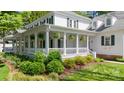 Elegant home with a sprawling porch, detailed columns, and mature landscaping at 18705 Harbor Light Blvd, Cornelius, NC 28031