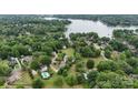 Lush, green aerial view of a lakeside community with pools and beautiful mature tree coverage at 188 Turnberry Ln, Mooresville, NC 28117