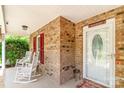 Cozy front porch with brick walls and white rocking chairs, offering a welcoming entrance at 2020 Olde Towne Dr, Monroe, NC 28110