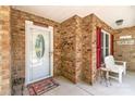 Charming front porch featuring brick accents, a welcoming bench, and a stylish front door at 2020 Olde Towne Dr, Monroe, NC 28110