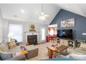 Cozy living room with fireplace, vaulted ceilings, and a view into the dining area at 2020 Olde Towne Dr, Monroe, NC 28110