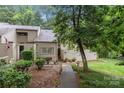 Exterior shot of the townhouse with natural landscaping and private patio at 222 Riverview Ter, Clover, SC 29710