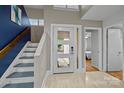 Bright foyer with modern door, staircase, and neutral decor creates a welcoming entrance and complements the home's design at 222 Riverview Ter, Clover, SC 29710