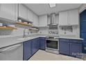 Modern kitchen features stainless steel appliances and stylish blue and gray cabinetry at 222 Riverview Ter, Clover, SC 29710