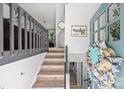 Light filled entry features decorative wreath, stairwell, and laminate flooring at 27037 Tidal Way, Tega Cay, SC 29708