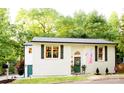 Beautiful house featuring a white exterior, lovely landscape, and patriotic decor at 27037 Tidal Way, Tega Cay, SC 29708
