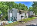 Charming home featuring gray shutters, an American flag, and level yard at 27037 Tidal Way, Tega Cay, SC 29708